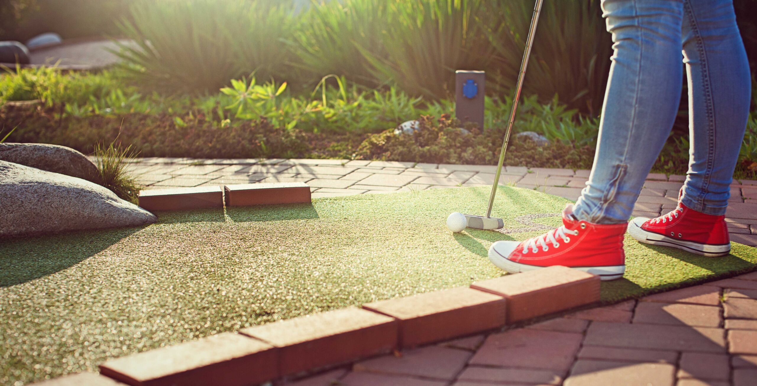 Miniature Golf - Feet and Woman Putting